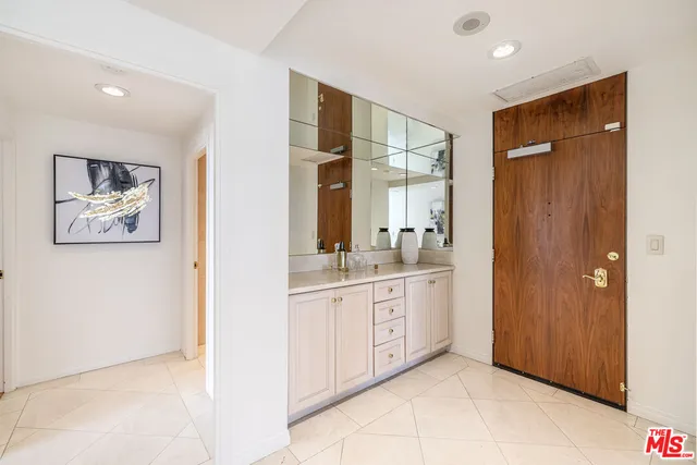 a spacious bathroom with a double vanity sink and a mirror