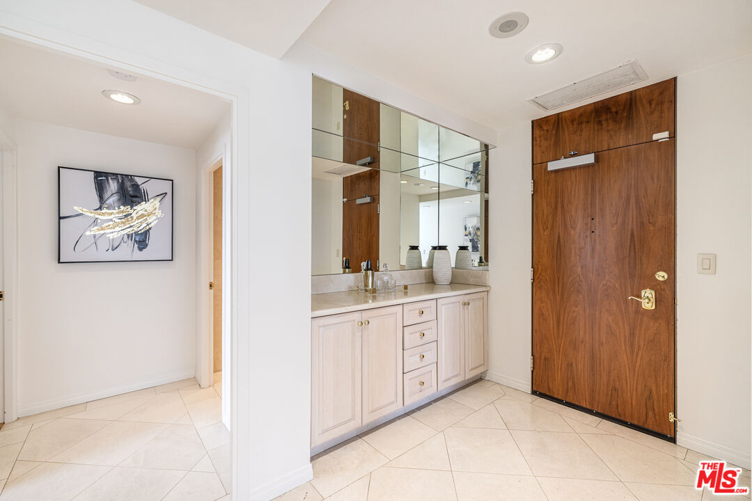 2220 Avenue Of The Stars, Unit 803 Los Angeles, CA 90067 - Photo 2 of 25 a spacious bathroom with a double vanity sink and a mirror