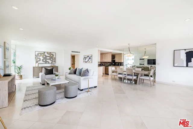 a living room with lots of furniture and white walls