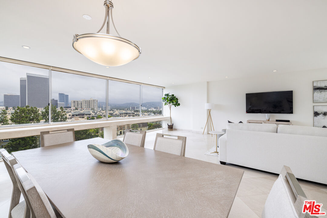 2220 Avenue Of The Stars, Unit 803 Los Angeles, CA 90067 - Photo 22 of 25 a living room with furniture and a flat screen tv
