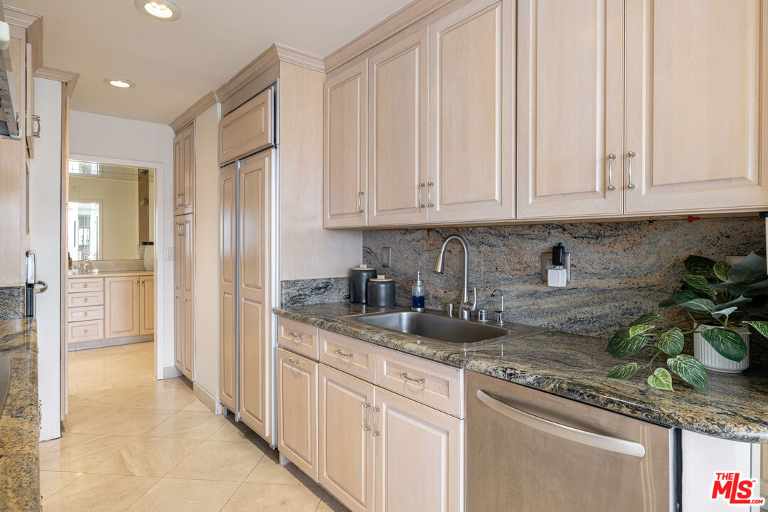 2220 Avenue Of The Stars, Unit 803 Los Angeles, CA 90067 - Photo 24 of 25 a kitchen with stainless steel appliances granite countertop white cabinets and a granite counter tops