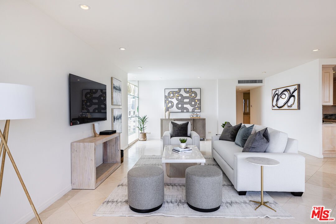 2220 Avenue Of The Stars, Unit 803 Los Angeles, CA 90067 - Photo 3 of 25 a living room with furniture and a flat screen tv