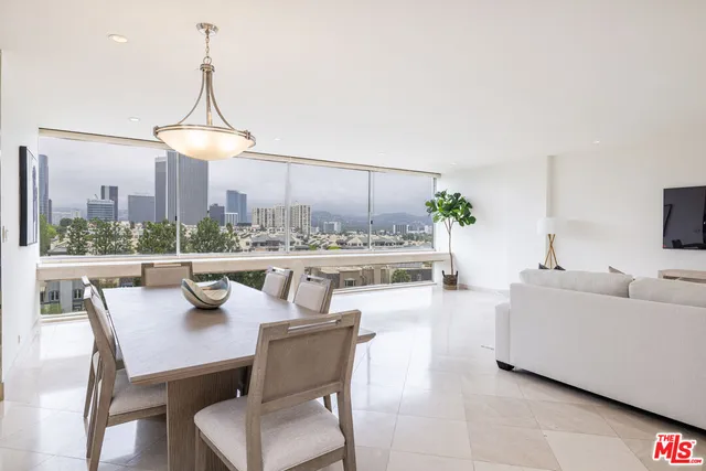 a dining room with furniture and a floor to ceiling window