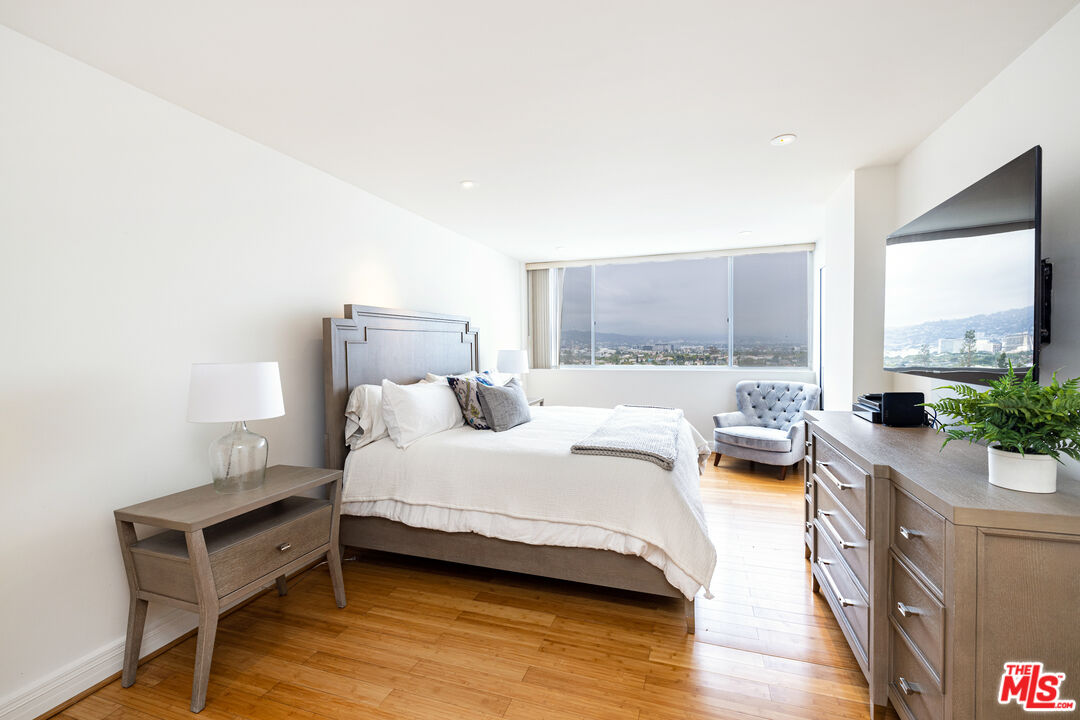 2220 Avenue Of The Stars, Unit 803 Los Angeles, CA 90067 - Photo 9 of 25 a bedroom with a bed and large windows