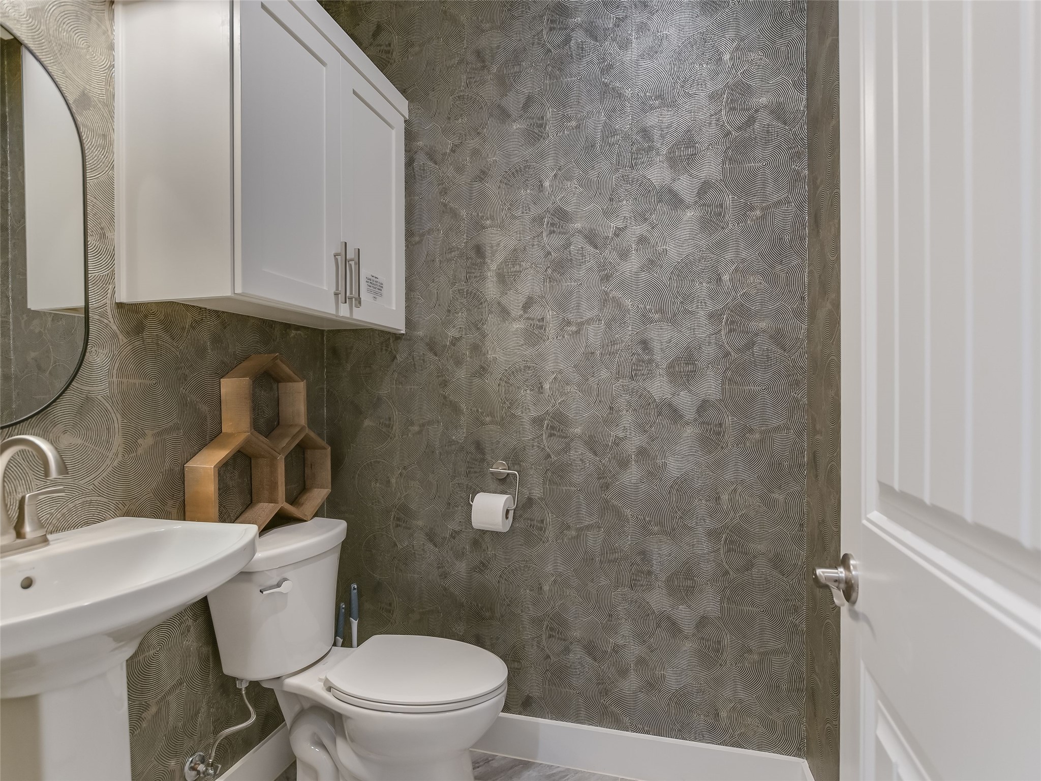 19819 Lockwood Road Manor, TX 78653 - Photo 18 of 29 With designer wallpaper and sleek finishes, the guest powder bath is anything but ordinary—a true conversation piece tucked right off the main living area.