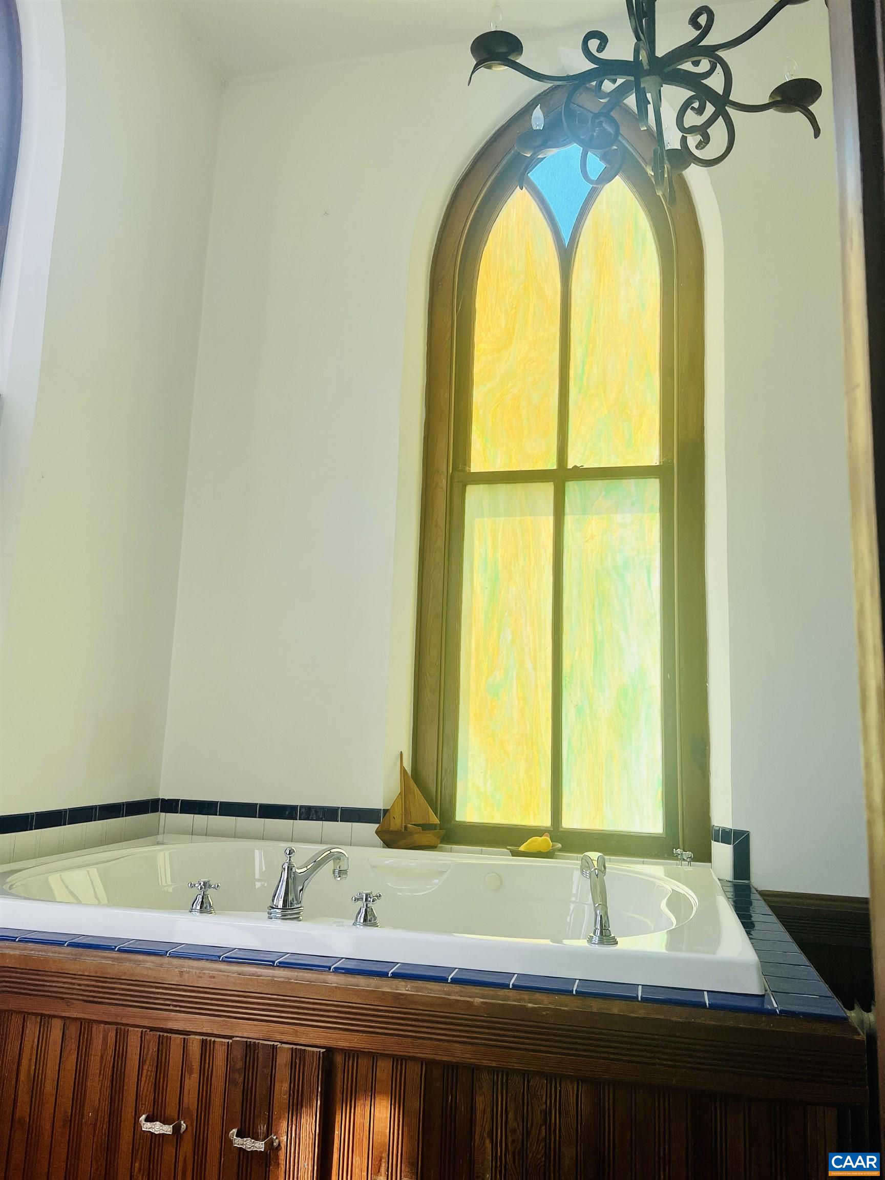 1105 Summerdean Road Middlebrook, VA 24459 - Photo 31 of 75 a bathroom with a granite countertop tub and a window