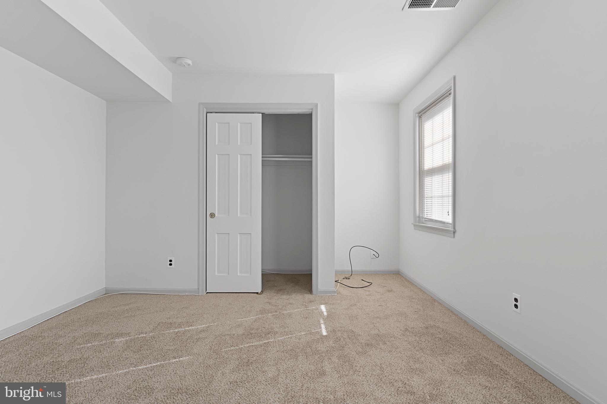 3800 V Street Southeast, Unit 101 Washington, DC 20020 - Photo 22 of 28 an empty room with windows