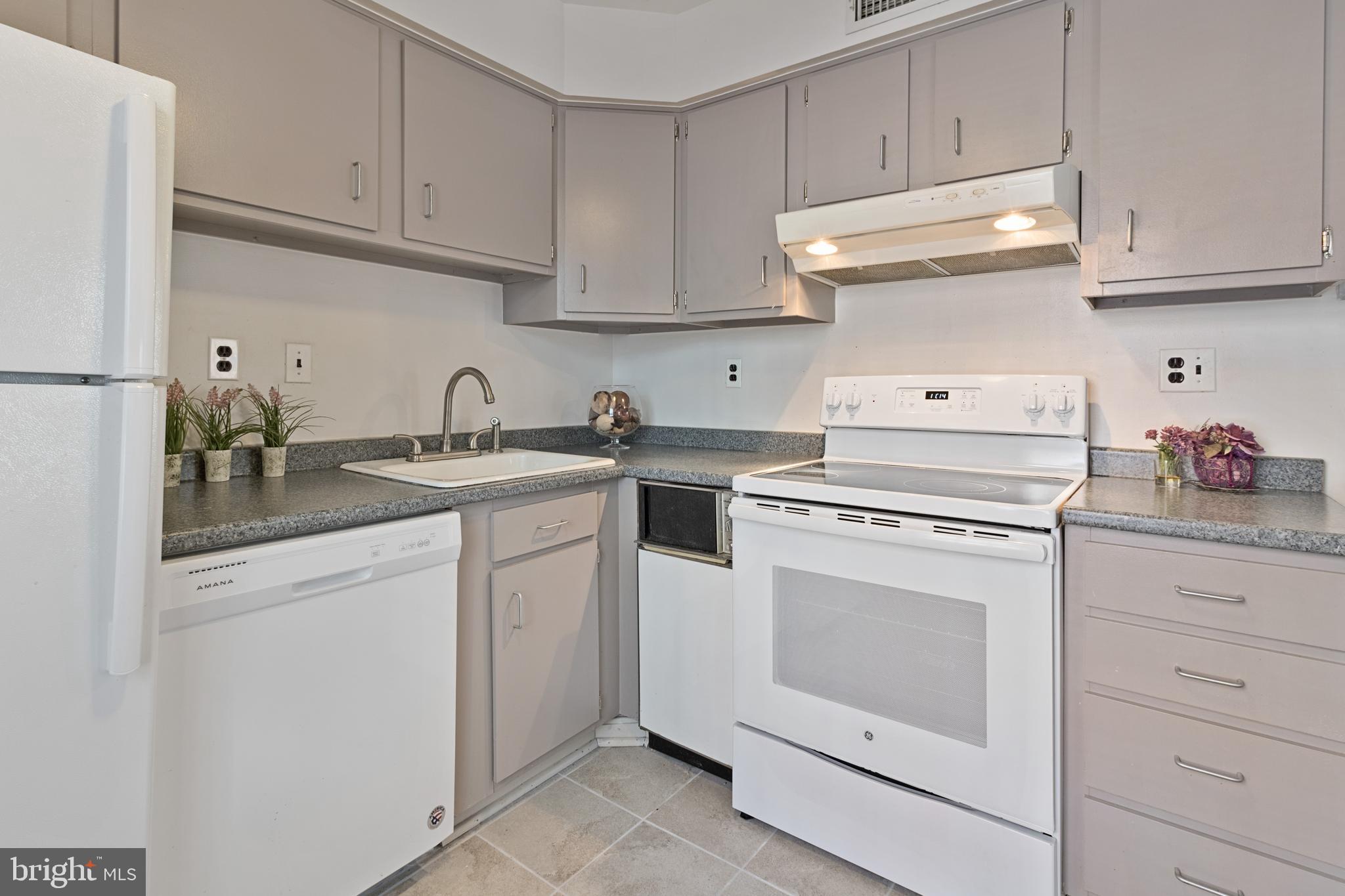 3800 V Street Southeast, Unit 101 Washington, DC 20020 - Photo 5 of 28 a kitchen with white cabinets and white appliances