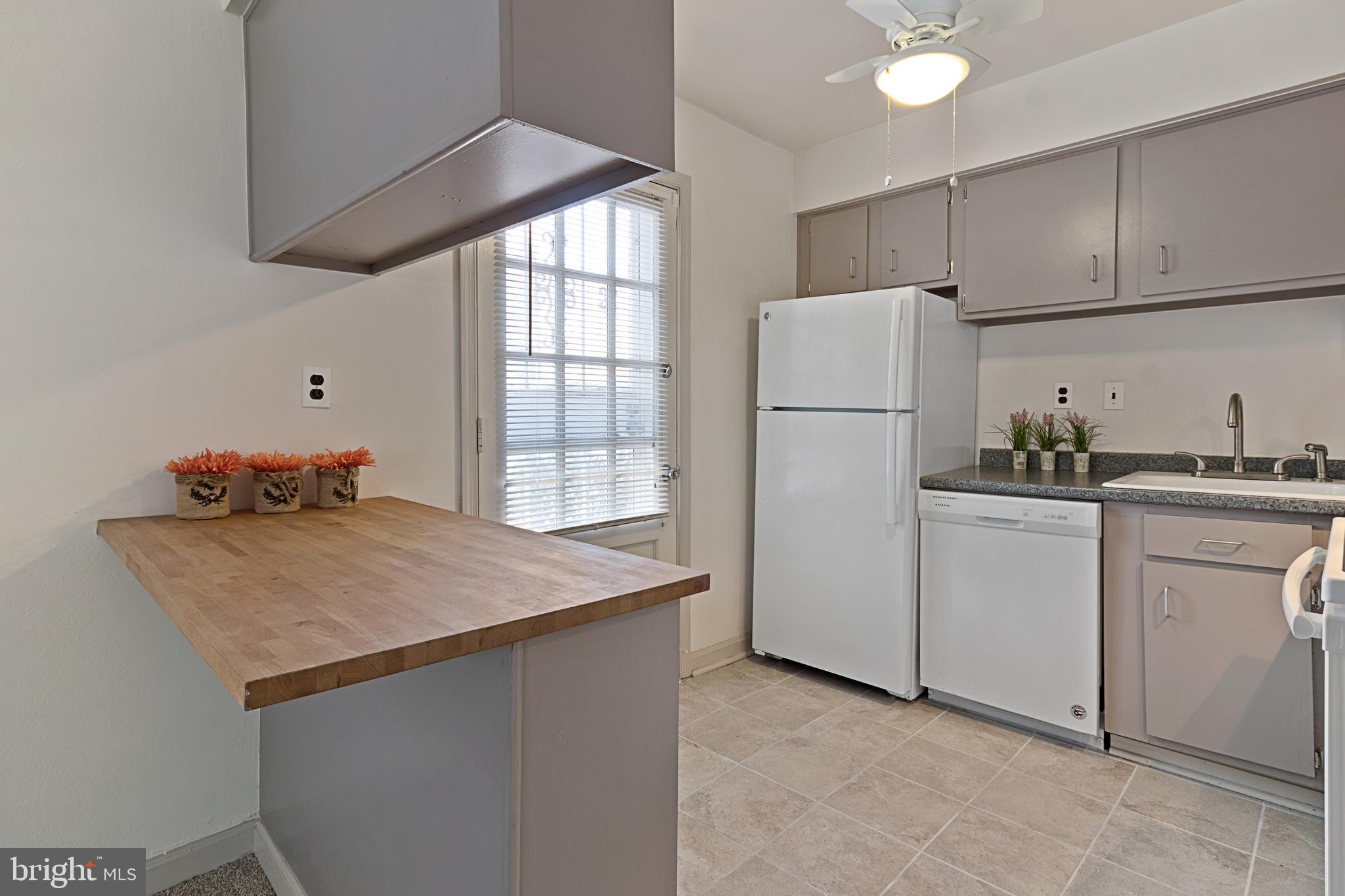 3800 V Street Southeast, Unit 101 Washington, DC 20020 - Photo 7 of 28 a utility room with cabinets washer and dryer