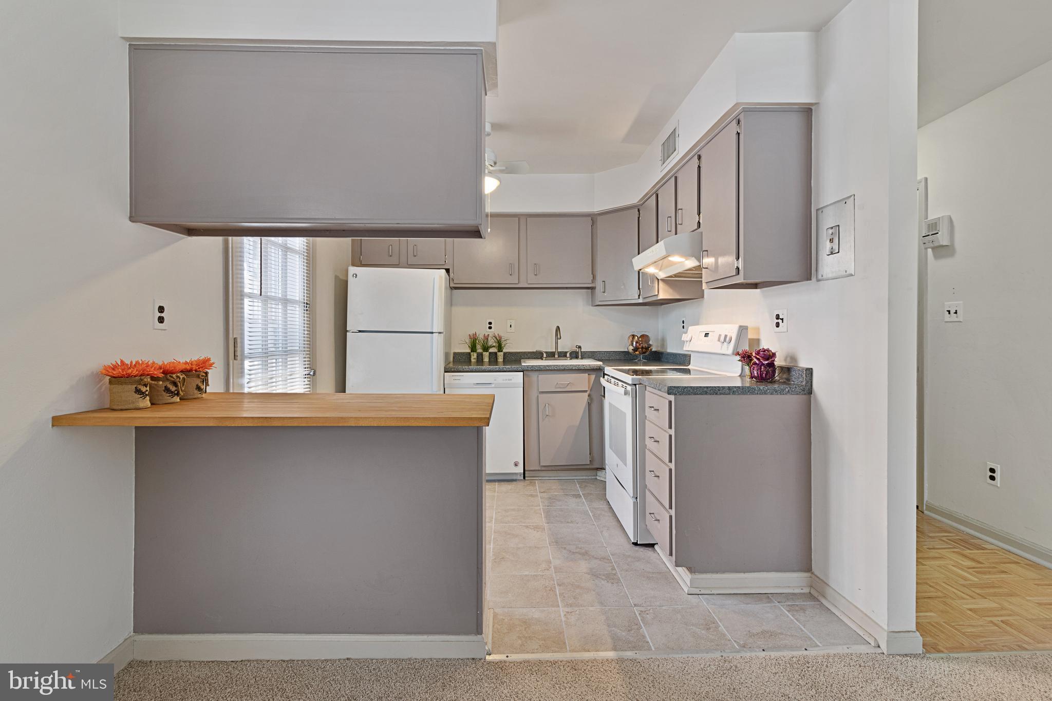 3800 V Street Southeast, Unit 101 Washington, DC 20020 - Photo 8 of 28 a kitchen with stainless steel appliances granite countertop a sink a stove and a refrigerator