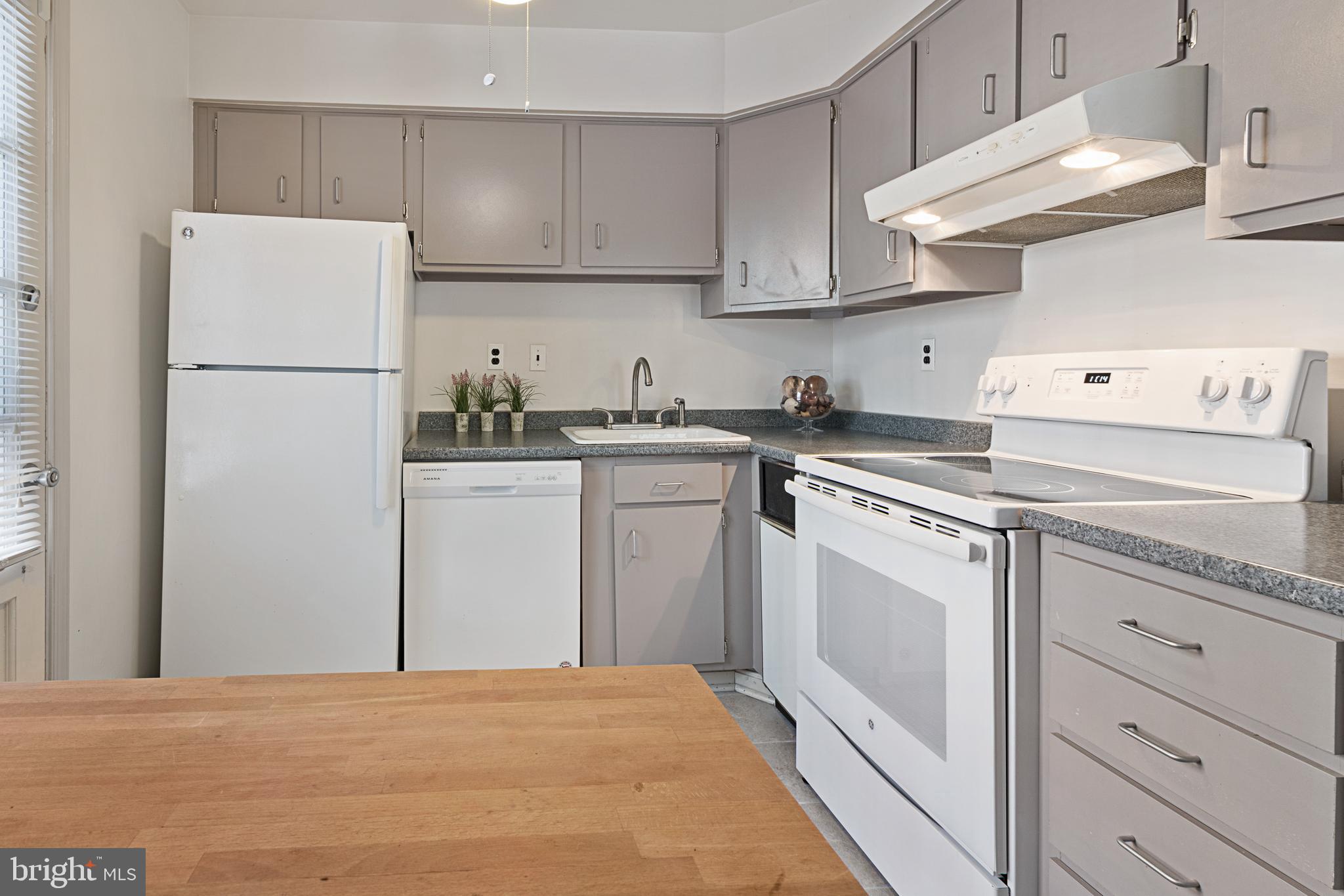 3800 V Street Southeast, Unit 101 Washington, DC 20020 - Photo 9 of 28 a kitchen with white cabinets and white appliances