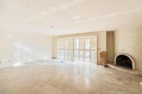 14721 East Tulare Avenue Sanger, CA 93657 - Photo 13 of 21 a view of an empty room with a fireplace and a large window