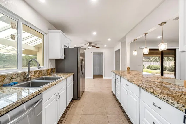 a view of entryway with a ceiling fan and window