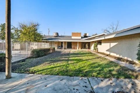 14721 East Tulare Avenue Sanger, CA 93657 - Photo 2 of 21 a front view of a house with a yard