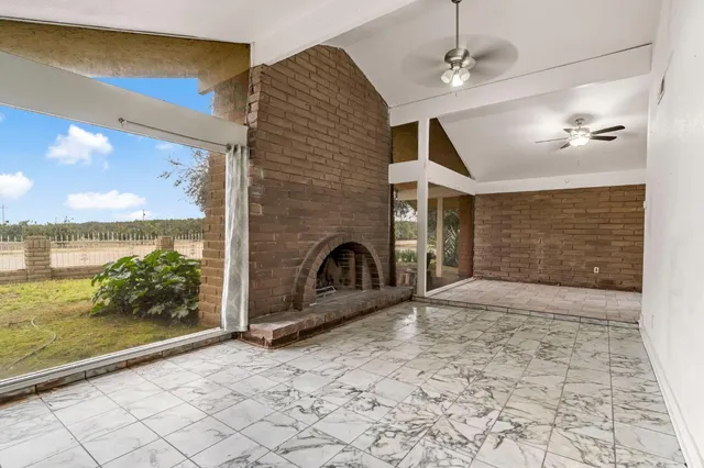a view of an empty room with a fireplace