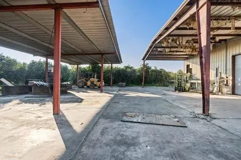 a view of a patio with a table and chairs under an umbrella