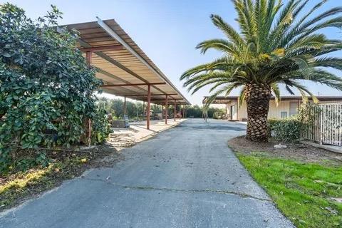 14721 East Tulare Avenue Sanger, CA 93657 - Photo 10 of 21 a backyard of a house with palm trees