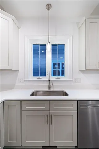 a kitchen with a sink and cabinets