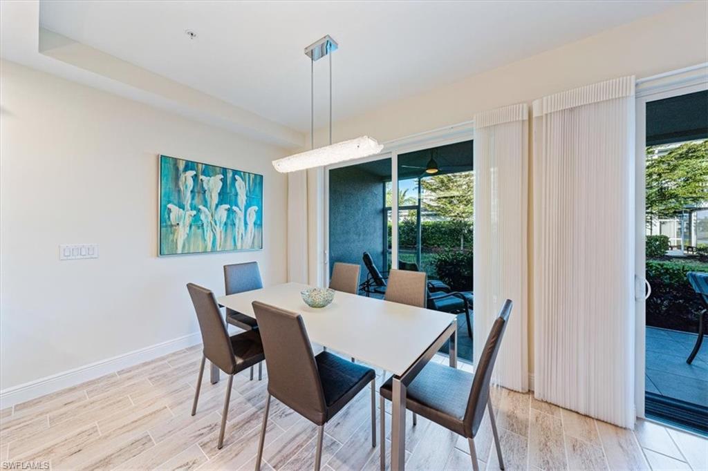 6934 Avalon Circle, Unit 402 Naples, FL 34112 - Photo 13 of 28 a view of a dining room with furniture window and wooden floor