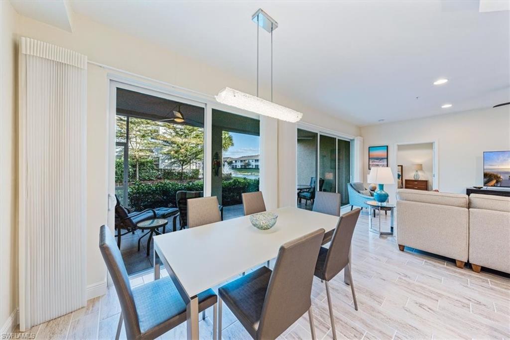 6934 Avalon Circle, Unit 402 Naples, FL 34112 - Photo 14 of 28 a view of a dining room with furniture window and wooden floor