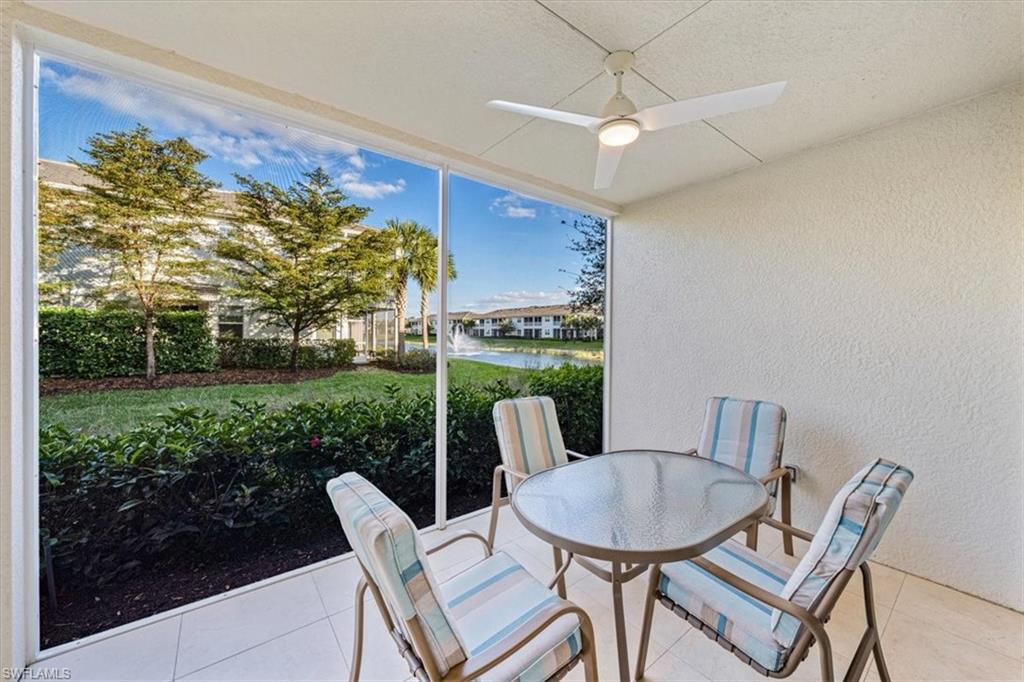 6934 Avalon Circle, Unit 402 Naples, FL 34112 - Photo 16 of 28 a view of a patio with a table and chairs