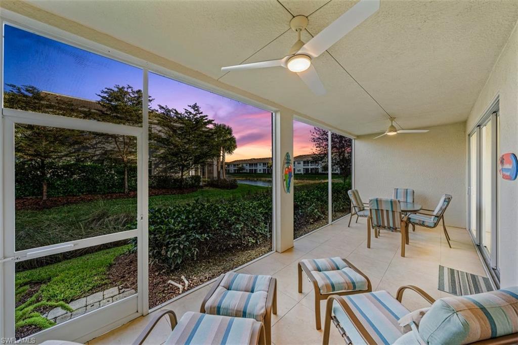 6934 Avalon Circle, Unit 402 Naples, FL 34112 - Photo 17 of 28 a view of a porch with furniture and a yard