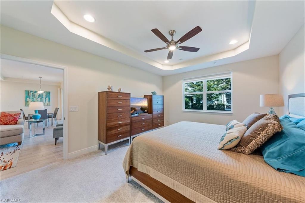 6934 Avalon Circle, Unit 402 Naples, FL 34112 - Photo 21 of 28 a bedroom with a large bed and a window