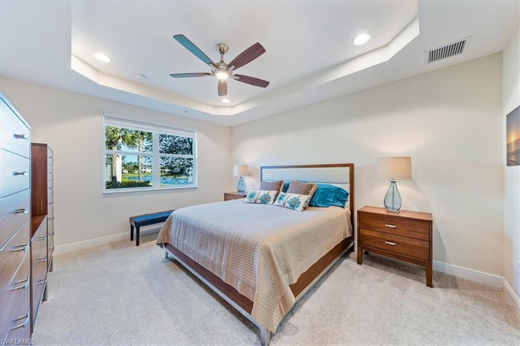 6934 Avalon Circle, Unit 402 Naples, FL 34112 - Photo 22 of 28 a bedroom with a bed and a window