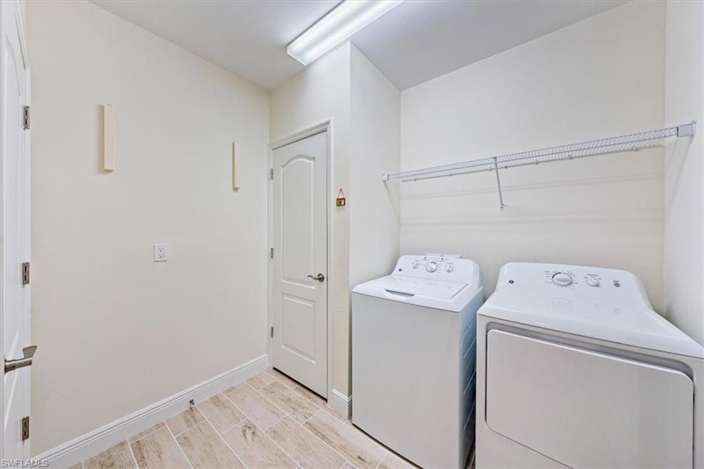 6934 Avalon Circle, Unit 402 Naples, FL 34112 - Photo 25 of 28 a view of storage and utility room with washer and dryer