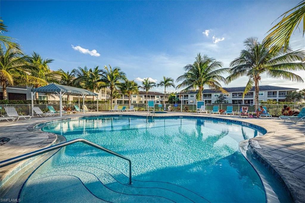 6934 Avalon Circle, Unit 402 Naples, FL 34112 - Photo 26 of 28 a view of a swimming pool with a patio