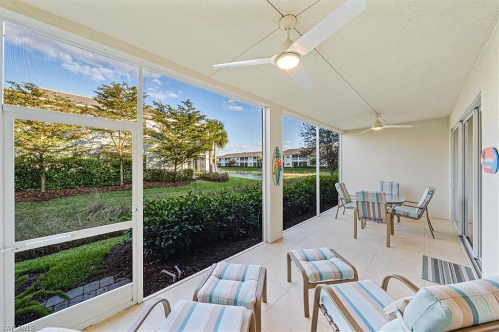 6934 Avalon Circle, Unit 402 Naples, FL 34112 - Photo 3 of 28 a view of a patio with a table chairs and a floor to ceiling window