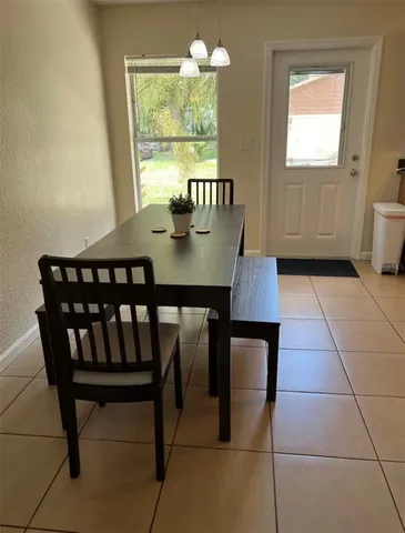 a view of a dining room with furniture and window