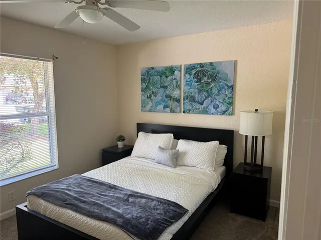 a bedroom with a bed and window