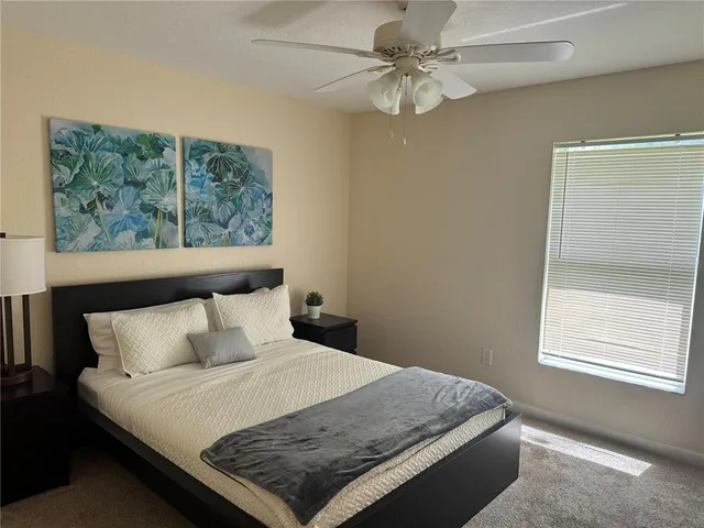 a bedroom with a bed window and wall painting