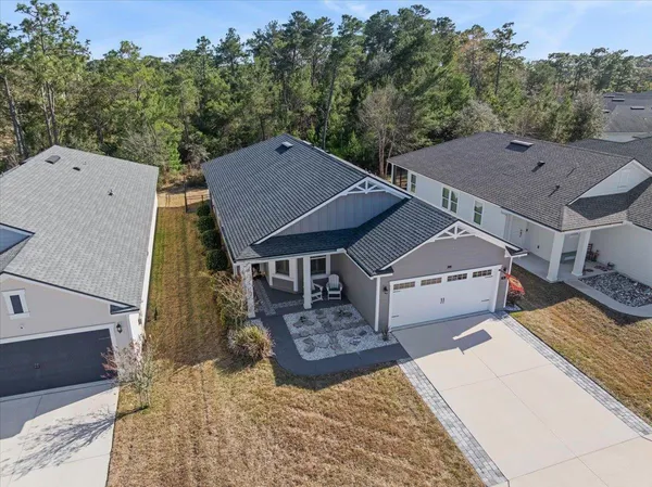 an aerial view of a house with swimming pool and big yard