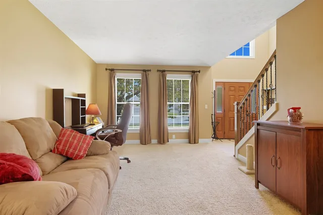 a living room with furniture gym equipment and a flat screen tv