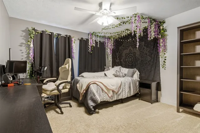 a bedroom with bed and a chandelier