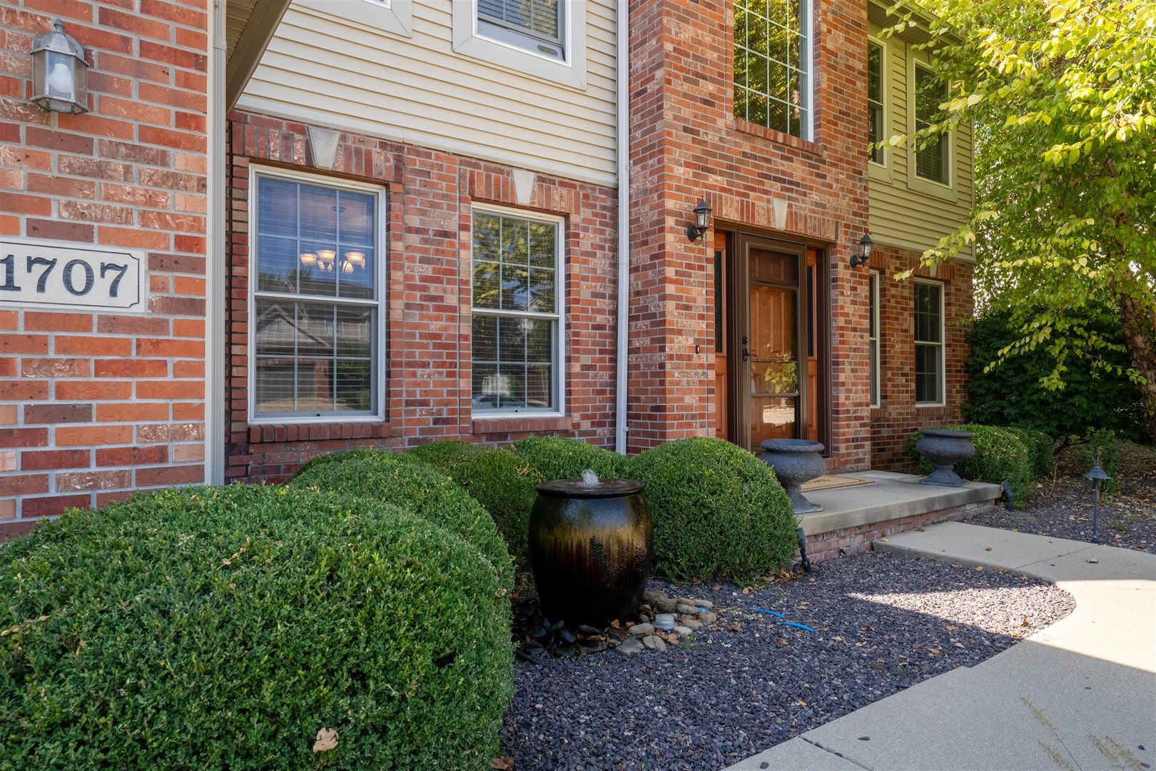 1707 Fraser Drive Normal, IL 61761 - Photo 2 of 33 a view of a brick house with a yard and plants