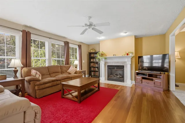 a living room with furniture flat screen tv and a fireplace