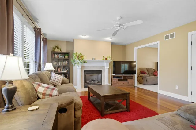 a living room with furniture fireplace and flat screen tv