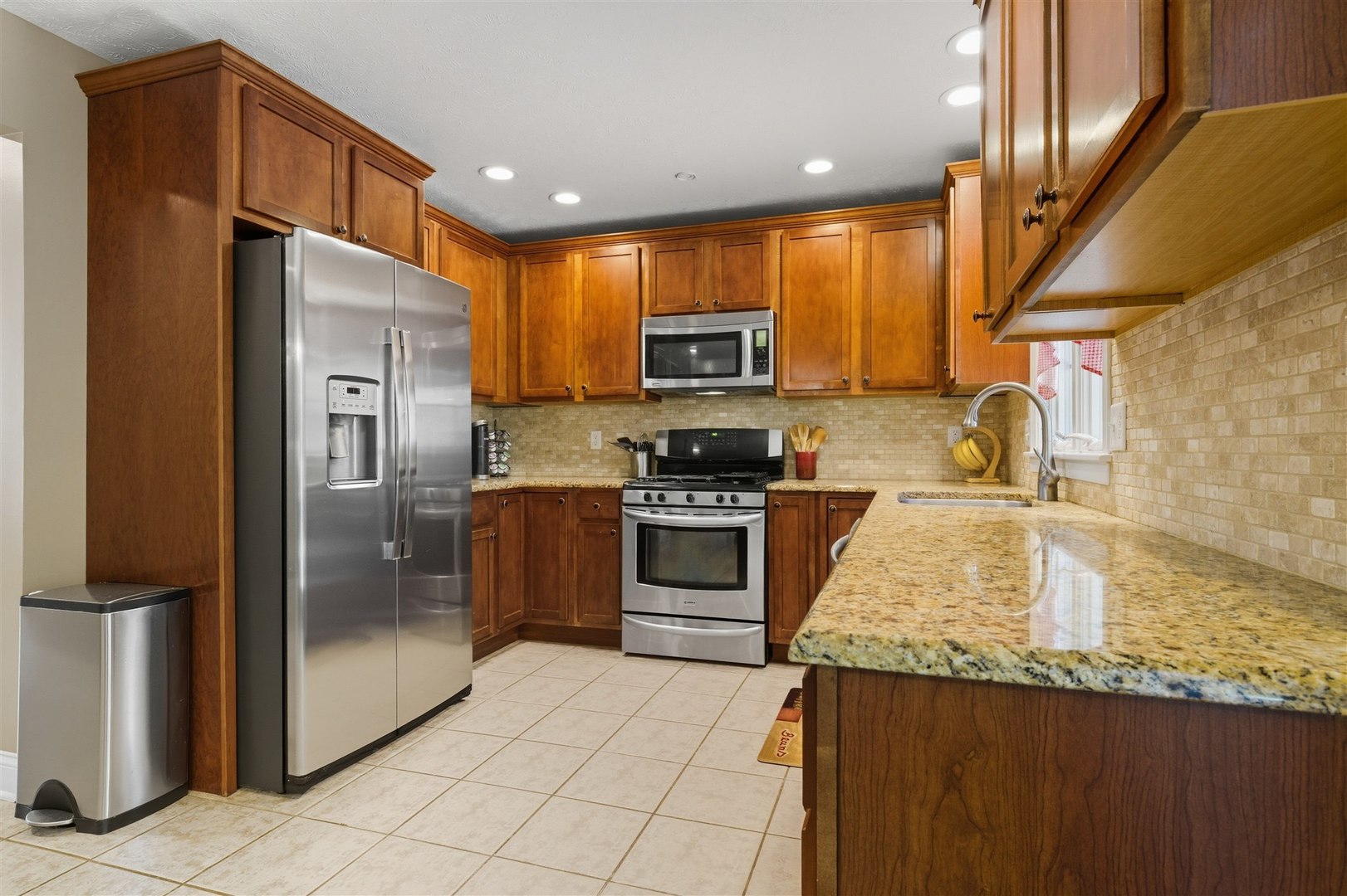 1707 Fraser Drive Normal, IL 61761 - Photo 10 of 33 a kitchen with stainless steel appliances granite countertop a refrigerator a stove and a sink