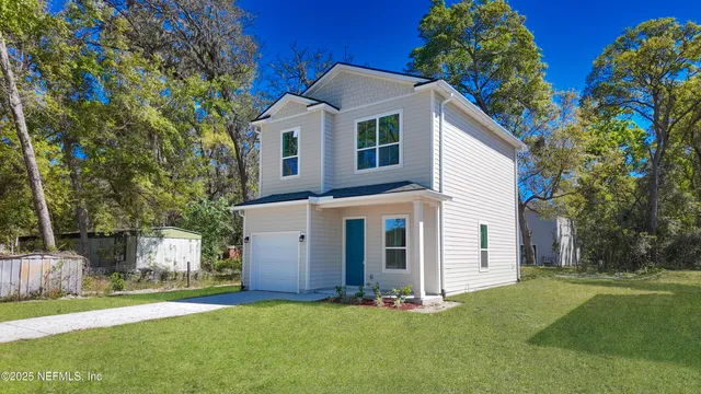 a front view of a house with a yard and garage
