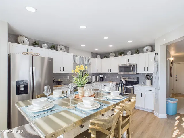 a kitchen with stainless steel appliances kitchen island granite countertop a sink and cabinets