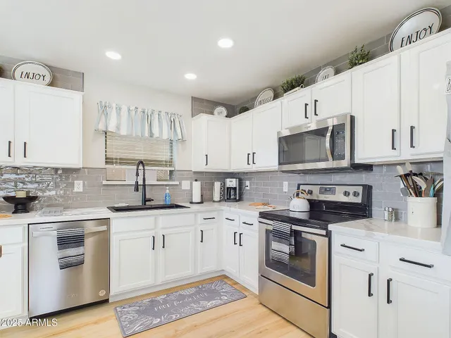 a bathroom with a granite countertop sink toilet a mirror and shower curtain