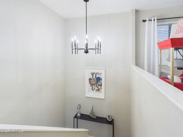 a bedroom with a bed couches and a flat tv screen on dresser