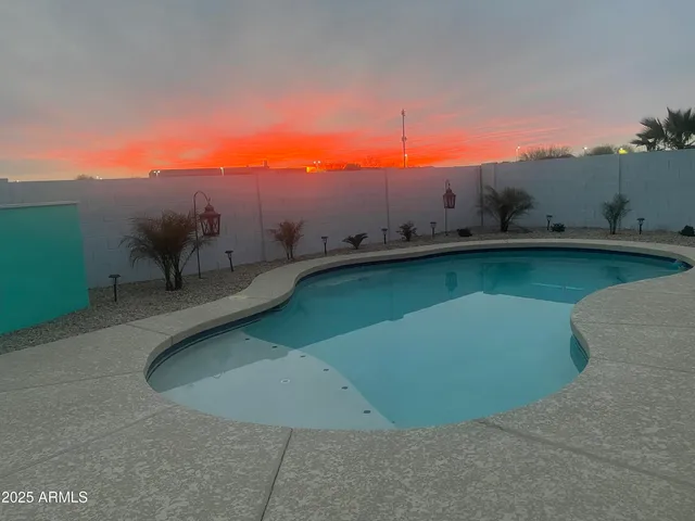 a view of a swimming pool with a yard