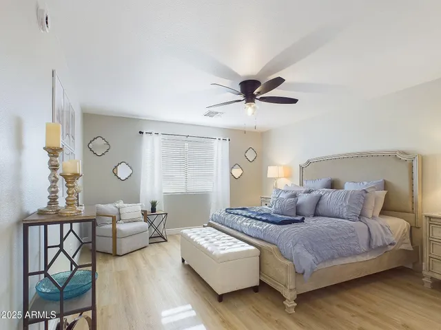 a bedroom with a bed and a chandelier