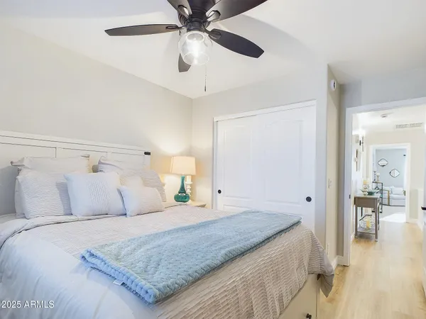 a bedroom with a bed and a lamp