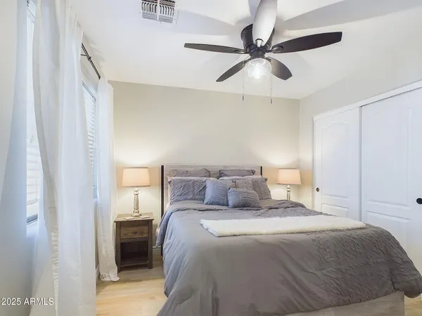 a view of a patio with table and chairs and potted plants with wooden floor and fence