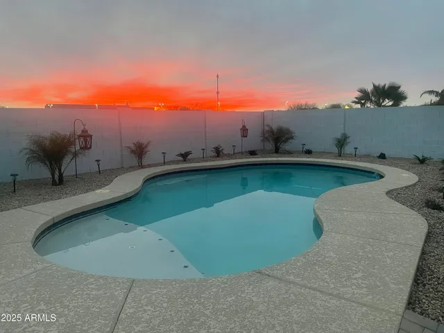 a view of a swimming pool with a yard and mountain